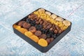 Mixed dried fruits box. Dried fruit background. Rows of dried dates, apricots, raisins, hazelnuts, dried apricots and figs Royalty Free Stock Photo