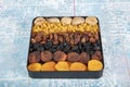 Mixed dried fruits box. Dried fruit background. Rows of dried dates, apricots, raisins, hazelnuts, dried apricots and figs Royalty Free Stock Photo