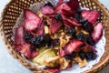 Mixed Dried Fruits Orange, Strawberry, Pineapple, Cherry and Apple Slices with Cinnamon Powder in Wooden Basket Royalty Free Stock Photo