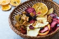 Mixed Dried Fruits Orange, Strawberry, Pineapple, Cherry and Apple Slices with Cinnamon Powder in Wooden Basket Royalty Free Stock Photo