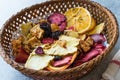 Mixed Dried Fruits Orange, Strawberry, Pineapple, Cherry and Apple Slices with Cinnamon Powder in Wooden Basket Royalty Free Stock Photo