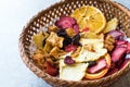 Mixed Dried Fruits Orange, Strawberry, Pineapple, Cherry and Apple Slices with Cinnamon Powder in Wooden Basket Royalty Free Stock Photo