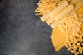 Mixed dried pasta selection on black wooden background