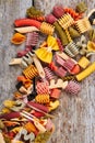 Mixed dried pasta selection on wooden background. Royalty Free Stock Photo