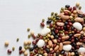 Mixed dry beans on white wooden board from above. Space for text Royalty Free Stock Photo
