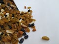 Mixed Dry fruits Scattered or dropping from Metal Container on white background