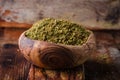 Mixed east spice - zaatar or zatar in vintage bowl on wooden background. Selective focus