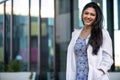 Mixed ethnicity college grad student in the medical field, possibly intern for dentistry, psychiatry, medicine, in lab coat Royalty Free Stock Photo