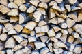 Mixed firewood stacked in a woodpile