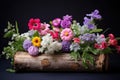 mixed flower arrangement in a hollowed-out log Royalty Free Stock Photo