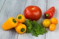 Mixed fresh colored vegetables, cherry tomatoes, mini paprika, tomato and fresh herbs on a wooden background Royalty Free Stock Photo