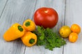 Mixed fresh colored vegetables, cherry tomatoes, mini paprika, tomato and fresh herbs on a wooden background Royalty Free Stock Photo