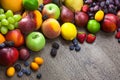 Mixed fresh Fruits on the wooden background with water drops