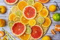 Mixed Fresh slices citrus fruit on a round wooden Board on a light background. Top view Royalty Free Stock Photo