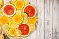 Mixed Fresh slices citrus fruit on a round wooden Board on a light background. Top view. With copy space Royalty Free Stock Photo