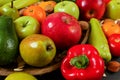 Mixed fruit - apples, pears, tangerines; and vegetable - peppers, tomatoes, avocados; with some whole almonds and nuts, closeup Royalty Free Stock Photo