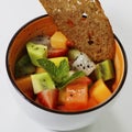 Mixed fruit bowl includes kiwi, berries, papaya, pineapple,dragonfruit, melon etc