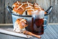 Mixed fruit and cinnamon easter hot cross buns with tea