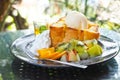 Fruit and Honey toast with Ice cream in black dish on table Royalty Free Stock Photo