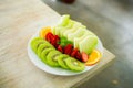 mixed fruit plate containing melon, strawberries, oranges and kiwi Royalty Free Stock Photo