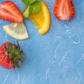 Mixed fruits and berries - strawberries, orange, lemon and mint leaves Royalty Free Stock Photo