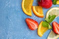 Mixed fruits and berries - strawberries, orange, lemon and mint leaves Royalty Free Stock Photo