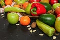 Mixed fruits and vegetables - red peppers, avocado, apples, pears, tangerines, pecan nuts, almonds and pumpkin seeds on wooden Royalty Free Stock Photo