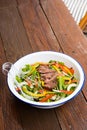 Gourmet mixed garden salad with red onion, bell peppers, zucchini and steak Royalty Free Stock Photo