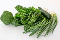 Mixed green vegetables on a white background