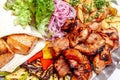 Mixed grill meat fried vegetables and grilled salmon fish fillets decoration in warm dish. Assorted delicious grilled kebab served Royalty Free Stock Photo