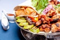 Mixed grill meat fried vegetables and grilled salmon fish fillets decoration in warm dish. Assorted delicious grilled kebab served Royalty Free Stock Photo