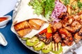 Mixed grill meat fried vegetables and grilled salmon fish fillets decoration in warm dish. Assorted delicious grilled kebab served Royalty Free Stock Photo