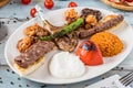 Mixed grill on wooden table. Lamb chops, Adana kebab, chicken shish, shish meatballs, steak Royalty Free Stock Photo