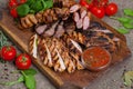 Mixed grilled meat platter. Assorted delicious grilled meat with vegetable. Royalty Free Stock Photo