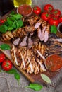 Mixed grilled meat platter. Assorted delicious grilled meat with vegetable. Royalty Free Stock Photo