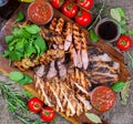 Mixed grilled meat platter. Assorted delicious grilled meat with vegetable. Royalty Free Stock Photo