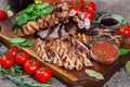 Mixed grilled meat platter. Assorted delicious grilled meat with vegetable. Royalty Free Stock Photo