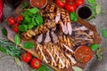 Mixed grilled meat platter. Assorted delicious grilled meat with vegetable. Royalty Free Stock Photo