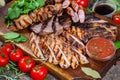 Mixed grilled meat platter. Assorted delicious grilled meat with vegetable. Royalty Free Stock Photo