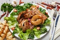 Mixed grilled meat platter. Beef, pork, sausages decorated with green lettuce leaves Royalty Free Stock Photo