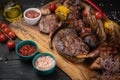 Mixed grilled meat platter on a black background Royalty Free Stock Photo