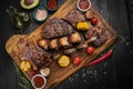 Mixed grilled meat platter on a black background Royalty Free Stock Photo