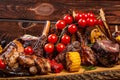 Mixed Grilled meat and vegetables on wooden background Royalty Free Stock Photo