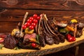 Mixed Grilled meat and vegetables on wooden background Royalty Free Stock Photo