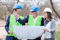 Mixed group of architects and business partners discussing project details during inspection of a construction site Royalty Free Stock Photo