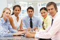 Mixed group in business meeting sat around table Royalty Free Stock Photo