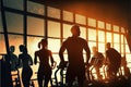 Mixed group of men and women of different ages in inclusive gym, fitness studio. Silhouettes of active sporty people on gym