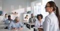 Mixed group of students listening to tutor in class Royalty Free Stock Photo