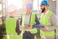 Group of young architects or business partners meeting on a construction site Royalty Free Stock Photo