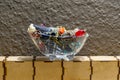 Mixed jewelry in a glass bathtub on top of wooden boxes